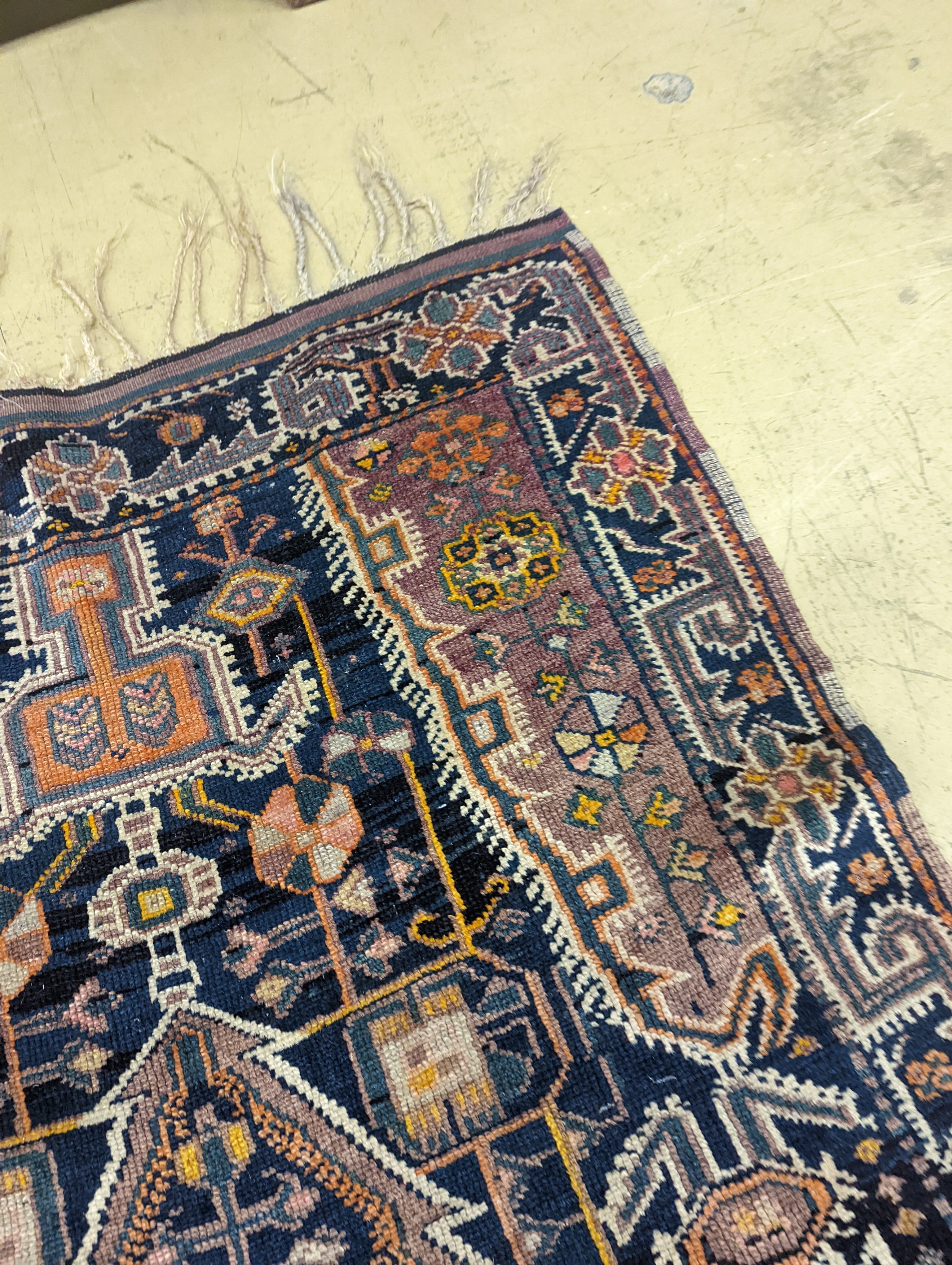 A Caucasian design blue ground rug, 224 x 111cm